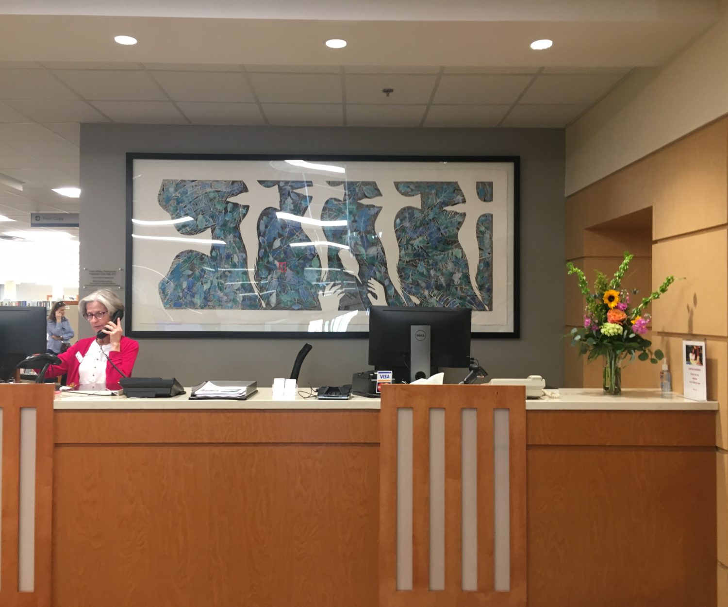 "Imagination Takes Flight" behind the reference and circulation desk.